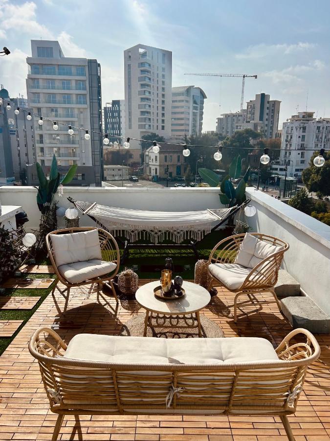 a patio with chairs and a couch on a roof at Heart Of Nicosia - The Gem in Nicosia