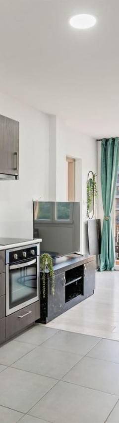 a kitchen with a stainless steel refrigerator and cabinets at Heart Of Nicosia - The Gem in Nicosia