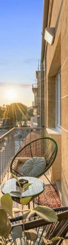 a balcony with two chairs and a view of a city at Heart Of Nicosia - The Gem in Nicosia