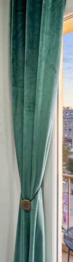 a window with a green curtain and a mirror at Heart Of Nicosia - The Gem in Nicosia