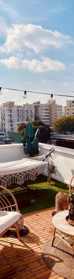 a patio with chairs and tables on a roof at Heart Of Nicosia - The Gem in Nicosia