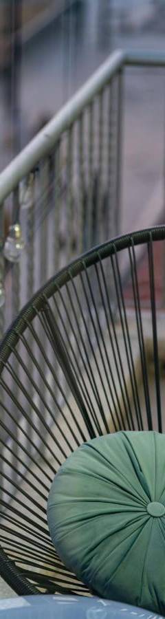 a green umbrella sitting on a chair on a balcony at Heart Of Nicosia - The Gem in Nicosia