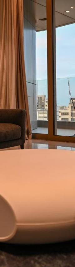 a living room with a couch and a table at The 1 -Nicosia Elite Stay- Gym Pool 24h Concierge in Nicosia