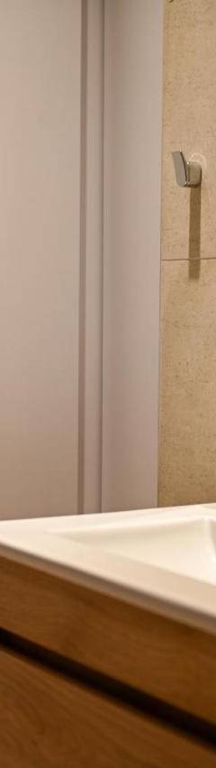 a bathroom with a white sink and a mirror at The 1 -Nicosia Elite Stay- Gym Pool 24h Concierge in Nicosia