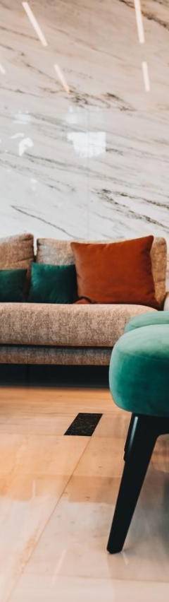 a living room with a green chair and a couch at The 1 -Nicosia Elite Stay- Gym Pool 24h Concierge in Nicosia