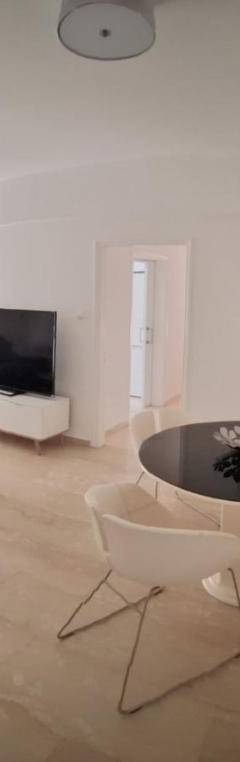 a living room with a couch and a table at Theo 202 - Cozy 2 Bdr Nicosia Free Parking &amp; Wi-Fi in Nicosia