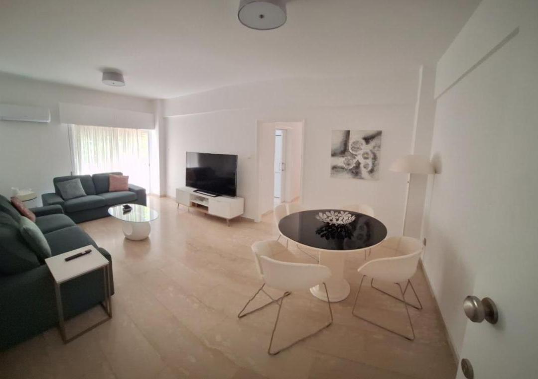 a living room with a couch and a table at Theo 202 - Cozy 2 Bdr Nicosia Free Parking &amp; Wi-Fi in Nicosia