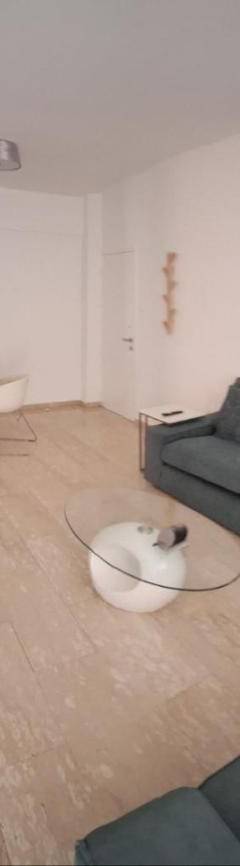 a living room with a couch and a tv at Theo 202 - Cozy 2 Bdr Nicosia Free Parking &amp; Wi-Fi in Nicosia