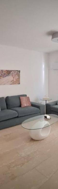 a living room with a couch and a tv at Theo 202 - Cozy 2 Bdr Nicosia Free Parking &amp; Wi-Fi in Nicosia