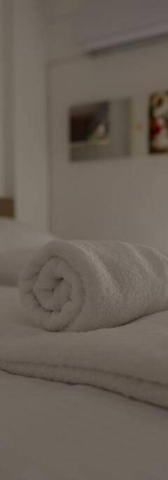 a bedroom with two towels on a bed at Theo 202 - Cozy 2 Bdr Nicosia Free Parking &amp; Wi-Fi in Nicosia