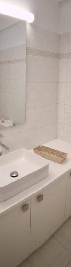 a white bathroom with a sink and a toilet at Theo 202 - Cozy 2 Bdr Nicosia Free Parking &amp; Wi-Fi in Nicosia