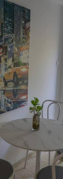 a kitchen with a table and chairs and a microwave at Theo 202 - Cozy 2 Bdr Nicosia Free Parking &amp; Wi-Fi in Nicosia