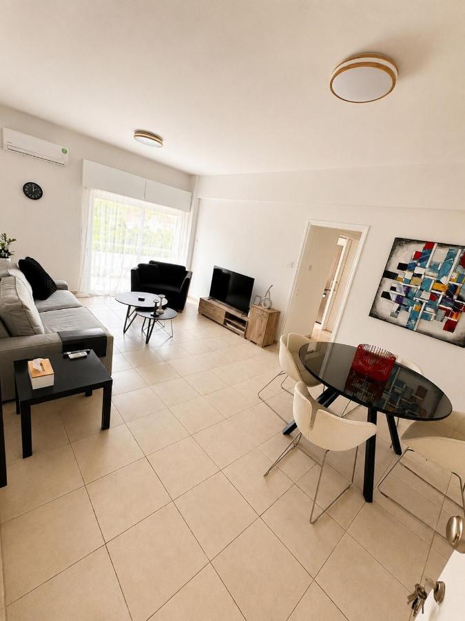 a living room with a couch and a table at Theo 302 - Comfort 2 Queen Bdr Nicosia with Parking in Nicosia