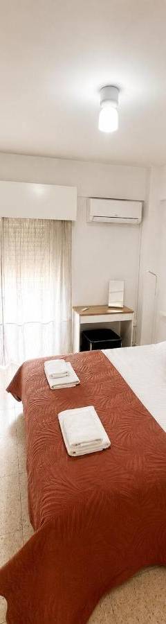 a bedroom with a large bed with towels on it at Theo 302 - Comfort 2 Queen Bdr Nicosia with Parking in Nicosia