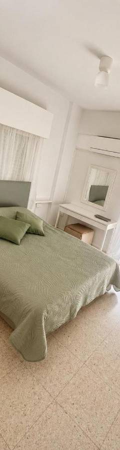 a bedroom with a bed and a table and windows at Theo 302 - Comfort 2 Queen Bdr Nicosia with Parking in Nicosia