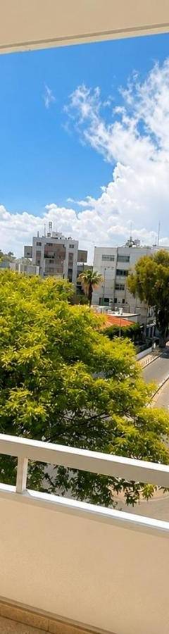 a balcony with a view of a city street at Theo 302 - Comfort 2 Queen Bdr Nicosia with Parking in Nicosia