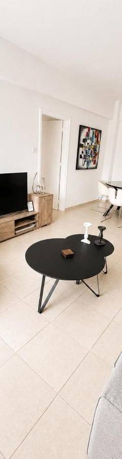 a living room with a couch and a table at Theo 302 - Comfort 2 Queen Bdr Nicosia with Parking in Nicosia