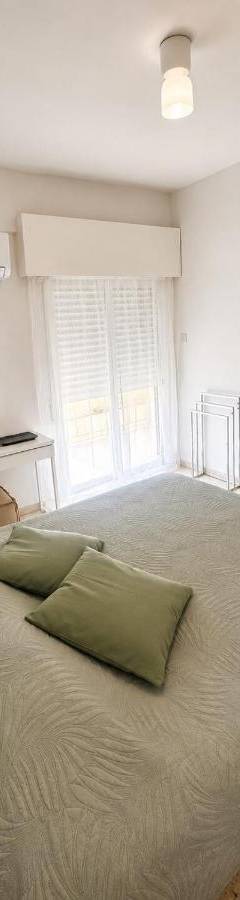 a bedroom with a bed with two pillows on it at Theo 302 - Comfort 2 Queen Bdr Nicosia with Parking in Nicosia