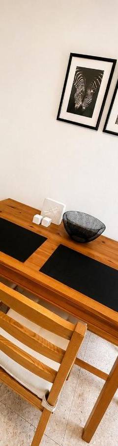 a wooden table and two chairs in a room at Theo 302 - Comfort 2 Queen Bdr Nicosia with Parking in Nicosia