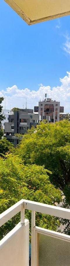 a balcony with a view of trees and buildings at Theo 302 - Comfort 2 Queen Bdr Nicosia with Parking in Nicosia