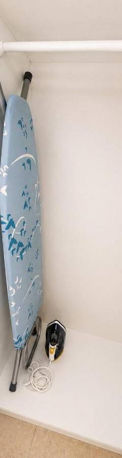 a room with a surfboard hanging on a wall at Theo 302 - Comfort 2 Queen Bdr Nicosia with Parking in Nicosia