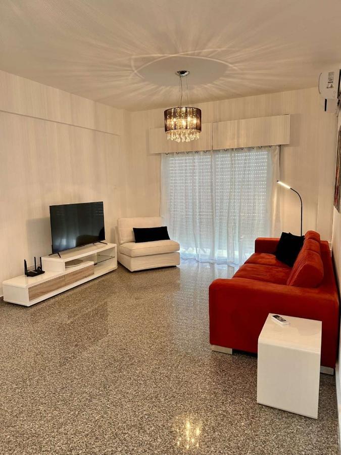 a living room with a couch and a flat screen tv at Theo 403 - Charming 2 Bdr Nicosia, Parking &amp; Wi-Fi in Nicosia