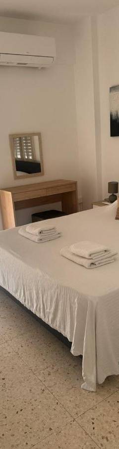 a bedroom with a large bed with towels on it at Theo 403 - Charming 2 Bdr Nicosia, Parking &amp; Wi-Fi in Nicosia