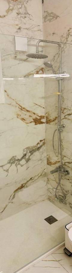 a bathroom with a toilet and a glass shower at Theo 403 - Charming 2 Bdr Nicosia, Parking &amp; Wi-Fi in Nicosia