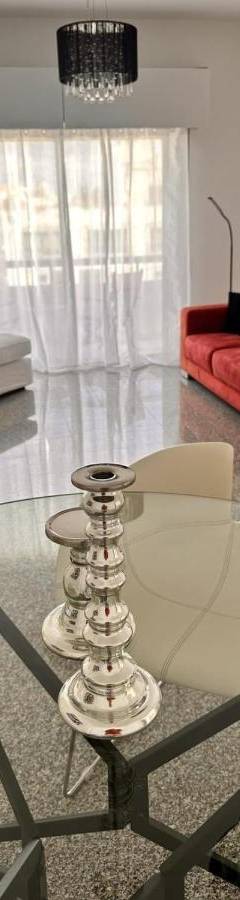 a living room with a glass table and a red couch at Theo 403 - Charming 2 Bdr Nicosia, Parking &amp; Wi-Fi in Nicosia