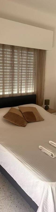 a bedroom with a bed with two towels on it at Theo 403 - Charming 2 Bdr Nicosia, Parking &amp; Wi-Fi in Nicosia