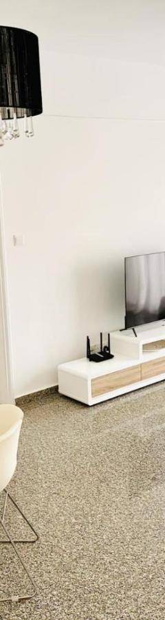 a living room with a glass table and white chairs at Theo 403 - Charming 2 Bdr Nicosia, Parking &amp; Wi-Fi in Nicosia