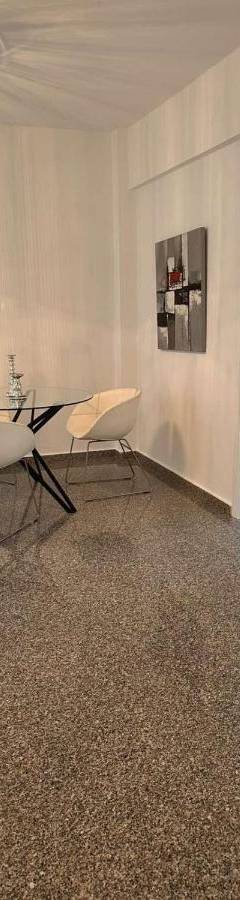 a dining room with a table and chairs and a chandelier at Theo 403 - Charming 2 Bdr Nicosia, Parking &amp; Wi-Fi in Nicosia