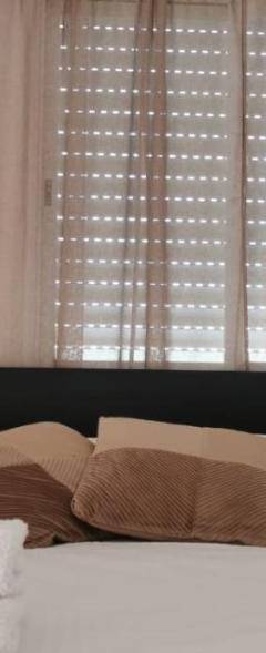 a bedroom with a bed with two pillows and a window at Theo 403 - Charming 2 Bdr Nicosia, Parking &amp; Wi-Fi in Nicosia