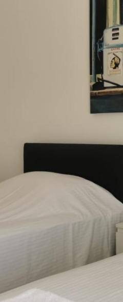 a bedroom with two beds and a picture on the wall at Theo 403 - Charming 2 Bdr Nicosia, Parking &amp; Wi-Fi in Nicosia