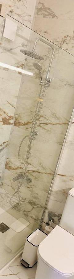 a bathroom with a toilet and a glass shower at Theo 403 - Charming 2 Bdr Nicosia, Parking &amp; Wi-Fi in Nicosia
