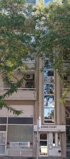 a building with trees in front of it at Theo 403 - Charming 2 Bdr Nicosia, Parking &amp; Wi-Fi in Nicosia