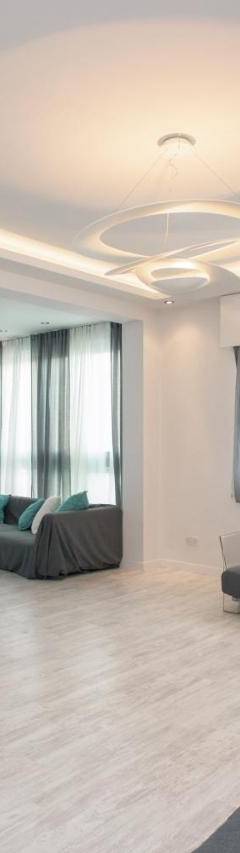 a living room with a couch and a flat screen tv at Mayra Seafront Luxury Apartment (BREAKBOOKING-CY) in Limassol