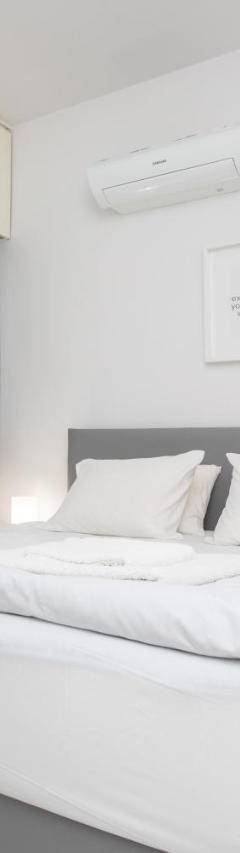 a bedroom with a large bed with white sheets and pillows at Mayra Seafront Luxury Apartment (BREAKBOOKING-CY) in Limassol