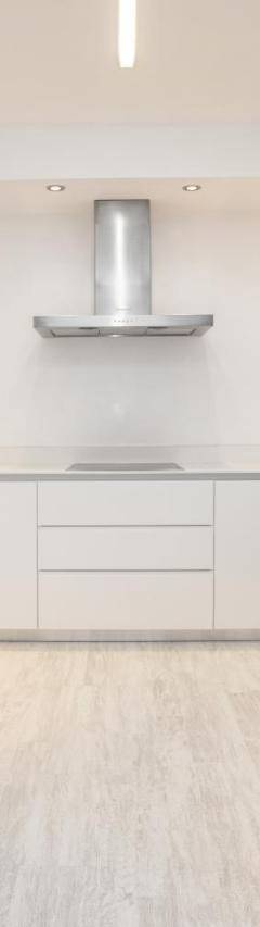 a kitchen with white cabinets and stainless steel appliances at Mayra Seafront Luxury Apartment (BREAKBOOKING-CY) in Limassol