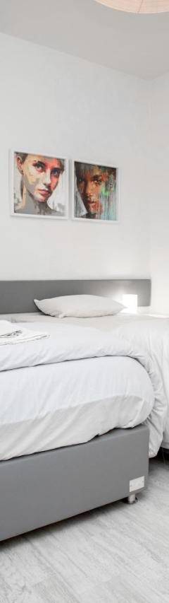 a white bedroom with a large bed in it at Mayra Seafront Luxury Apartment (BREAKBOOKING-CY) in Limassol