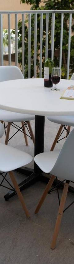 a white table and chairs on a balcony at Mayra Seafront Luxury Apartment (BREAKBOOKING-CY) in Limassol