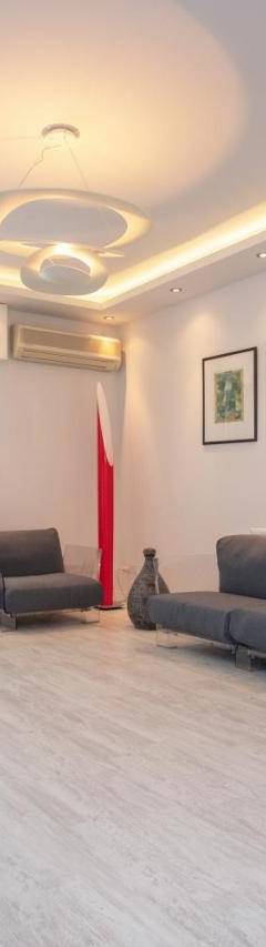 a living room with two couches and a television at Mayra Seafront Luxury Apartment (BREAKBOOKING-CY) in Limassol