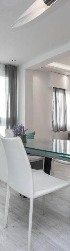 a living room with a couch and a table and chairs at Mayra Seafront Luxury Apartment (BREAKBOOKING-CY) in Limassol