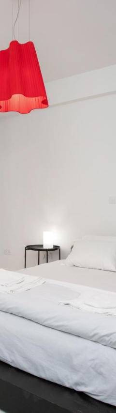 a white bedroom with a large bed in it at Mayra Seafront Luxury Apartment (BREAKBOOKING-CY) in Limassol