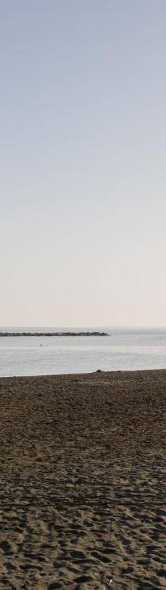 a beach with a group of people in the water at Mayra Seafront Luxury Apartment (BREAKBOOKING-CY) in Limassol