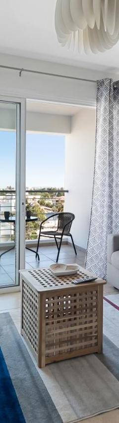 a living room with a couch and a television at Glabur Stays - The Sunny Atelier - Nicosia City, Free Parking &amp; Wifi, Welcomes You!!! in Nicosia