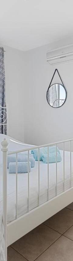 a white bedroom with a white bed and windows at Glabur Stays - The Sunny Atelier - Nicosia City, Free Parking &amp; Wifi, Welcomes You!!! in Nicosia