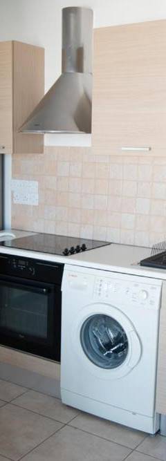 a kitchen with a washing machine and a refrigerator at Glabur Stays - The Sunny Atelier - Nicosia City, Free Parking &amp; Wifi, Welcomes You!!! in Nicosia