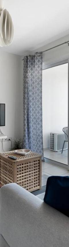a living room with a couch and a tv at Glabur Stays - The Sunny Atelier - Nicosia City, Free Parking &amp; Wifi, Welcomes You!!! in Nicosia