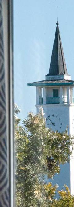 a clock tower with a steeple on top of a building at Glabur Stays - The Sunny Atelier - Nicosia City, Free Parking &amp; Wifi, Welcomes You!!! in Nicosia